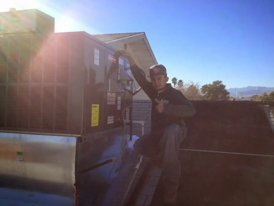 HVAC technician performing Air Duct Repair on a rooftop unit in Hillcrest Heights